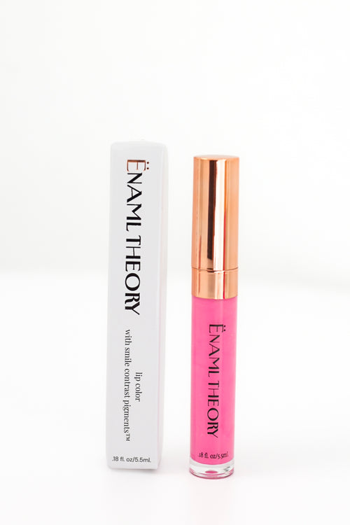 Enani Theory lip gloss in a vibrant pink shade, shown next to its white packaging box with black lettering on a clean white background.